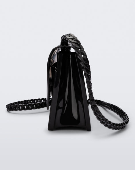 Side view of the Melissa party handbag in black with braided strap.