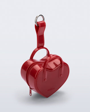 Angled view of a red Heartbeat Pocket bag charm