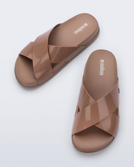 Top view of a pair of brown Cozy Cross sandals with crisscross top straps
