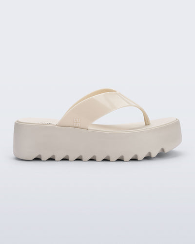 Side view of a beige Thong Platform flip flop
