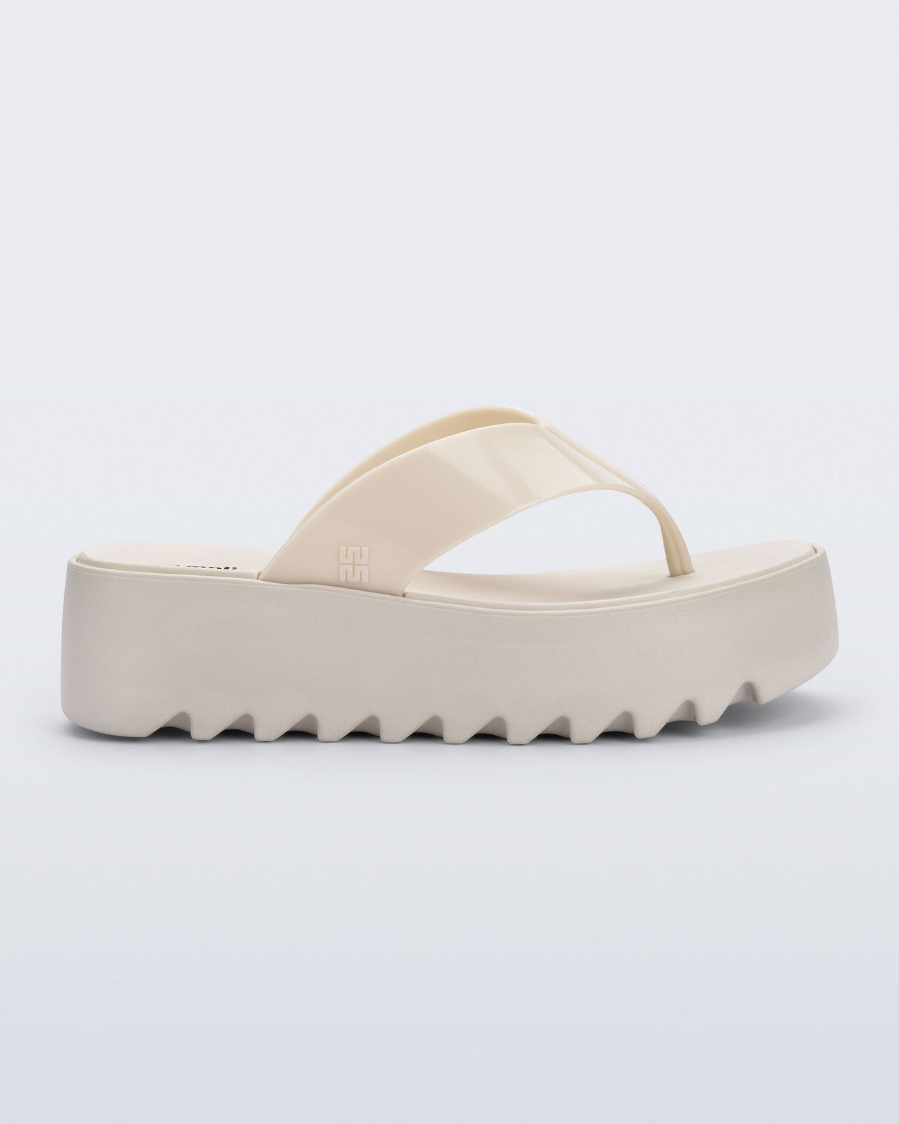 Side view of a beige Thong Platform flip flop