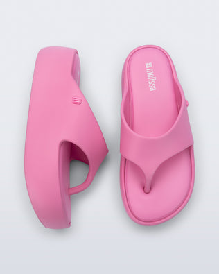 Side and top view of a pair of pink Free Platform Thong sandals