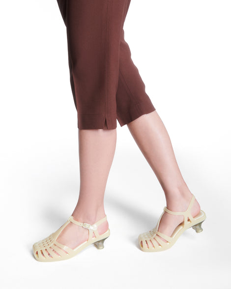 Model's legs wearing a pair of milky beige Vixen Kitten Heel Sandals