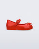 Side view of a red Sweet Love baby ballerina with red bow