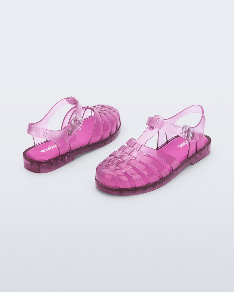 Back and angled view of a pair of transparent pink Possession fisherman sandals