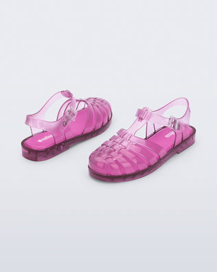 Back and angled view of a pair of transparent pink Possession fisherman sandals