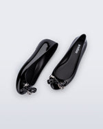 Side and top view of a pair of black Sweet Love Glam ballerina flats with chrome bow