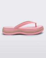 Side view of a pink/beige Melissa Leblon platform flip flop with details that mimic sisal braids on the sole and strap