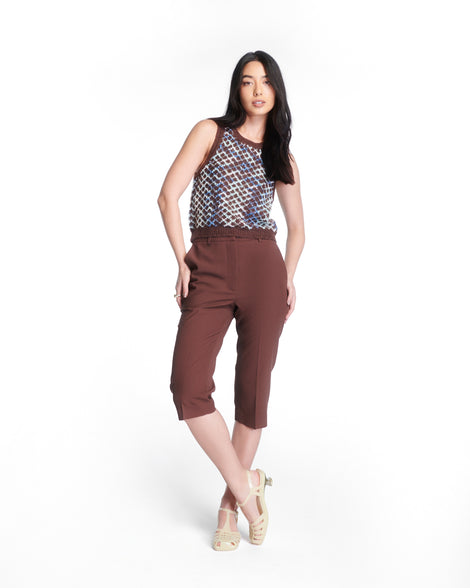 Model in a brown capris and brown patterned top wearing a pair of milky beige Vixen Kitten Heel Sandals