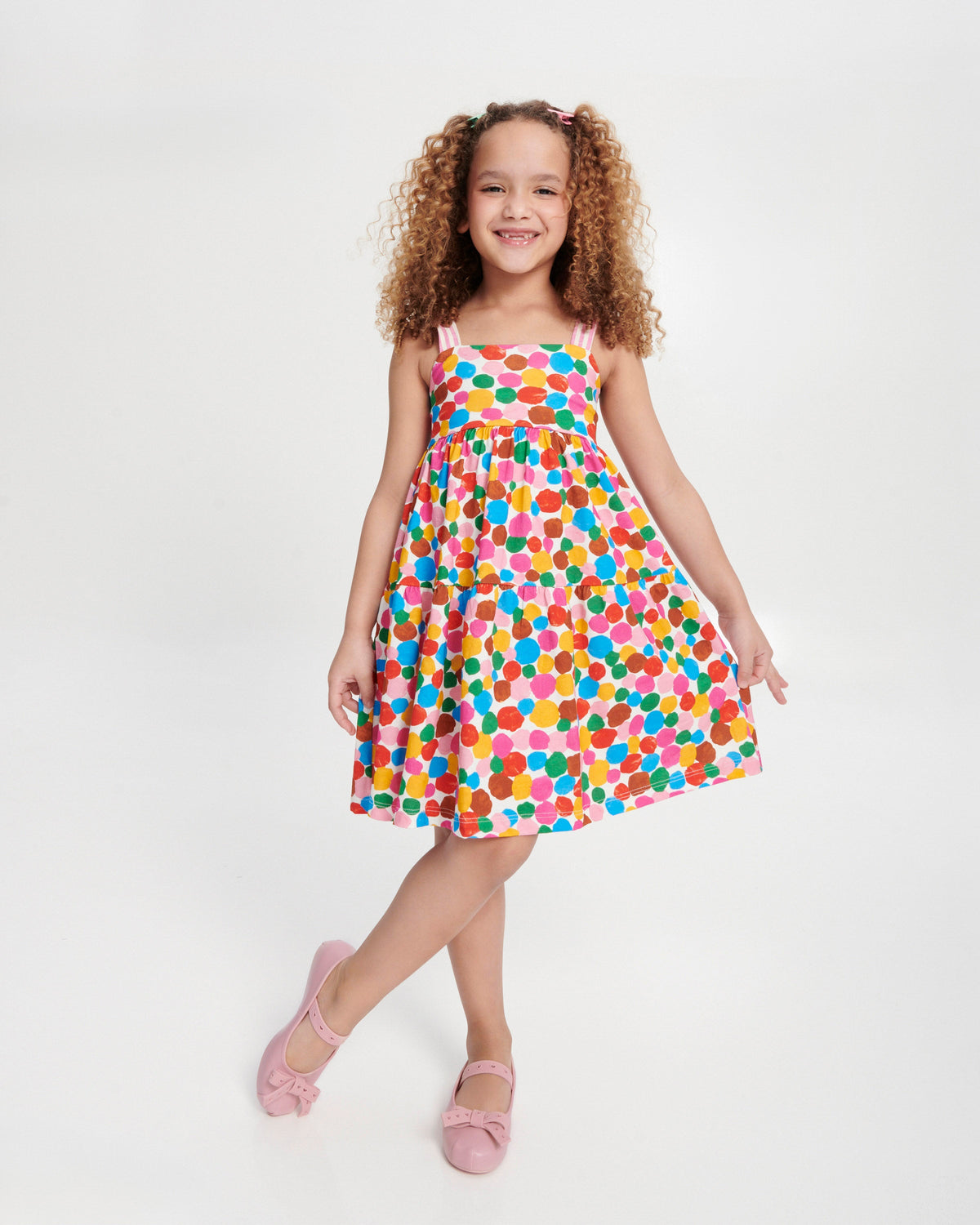 Child model in a polka dot dress wearing a pair of pink Sophie Crush kids ballerina flats with bow