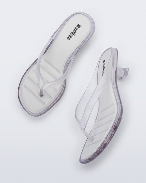 Top and side view of a pair of clear Flip Flop Kitten Heels with white insole