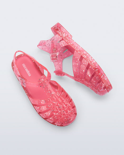 Side and top view of a pair of pink Possession kids sandals with heart glitter