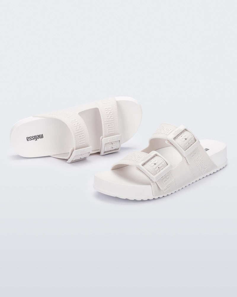 Top and angled view of a pair of white Cozy M Love adult slides