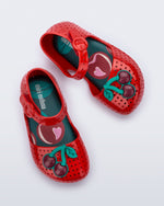 Top view of a pair of red Pop baby flats with two dark red cherries