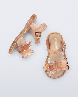 Top and side view of a pair of glitter beige baby Butterfly sandals with beige butterflies