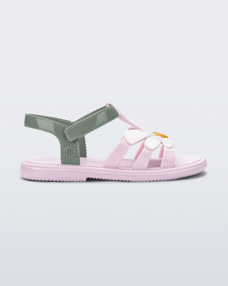 Side view of a kids pink and green Hip Bloomy sandal