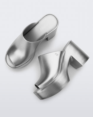 Top and side view of a pair of light silver Mule Hype Platforms