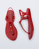 Top and Side view of a pair of red Solar Boho t-strap sandals with ,metallic detailing on the front strap