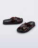 Side and angled view of a pair of black/tortoise Cozy Cross sandals with crisscross top straps