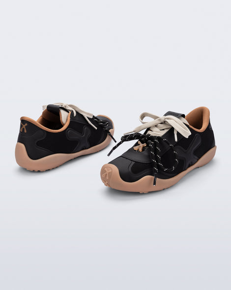 Back and angled view of a pair of black X Bend sneakers with beige sole