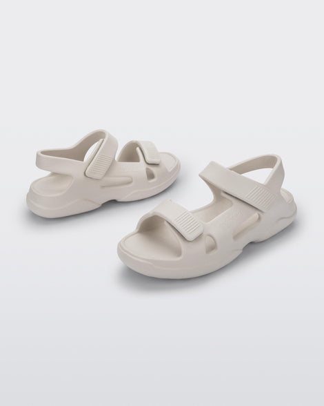 Angled view of a pair of beige Free Papete sandals