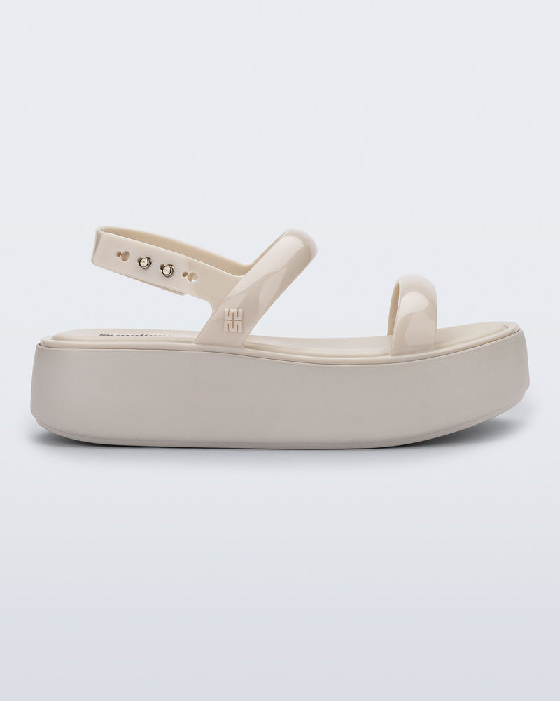 Side view of a beige Wave Platform sandal with top and heel straps