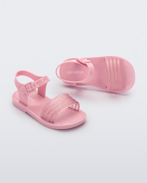 Top and angled view of a pair of pink Mar Wave baby sandals.