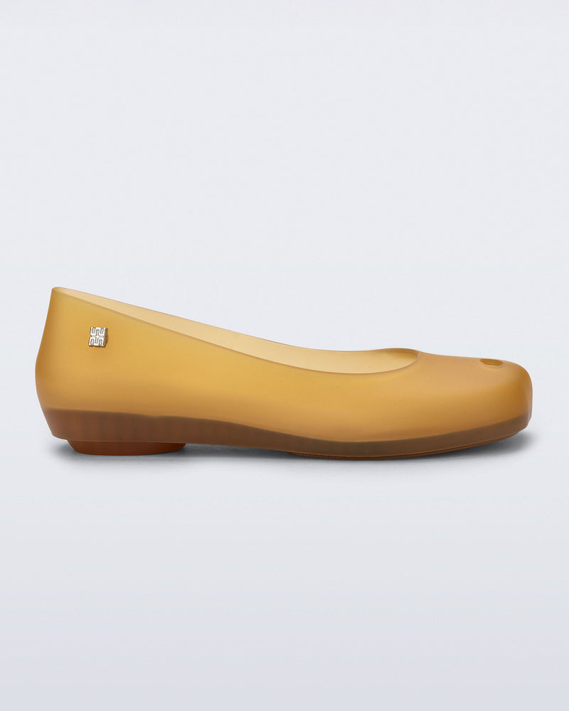 Side view of a clear yellow Ultragirl Futura ballerina flat