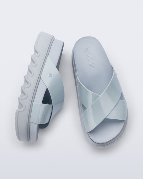 Top and side view of a pair of blue Cozy Cross platform sandals with crisscross top straps