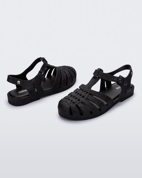 Back and angled view of a pair of glitter black Possession fisherman sandal