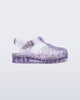 Side view of a clear lilac Possession baby sandal with star glitter