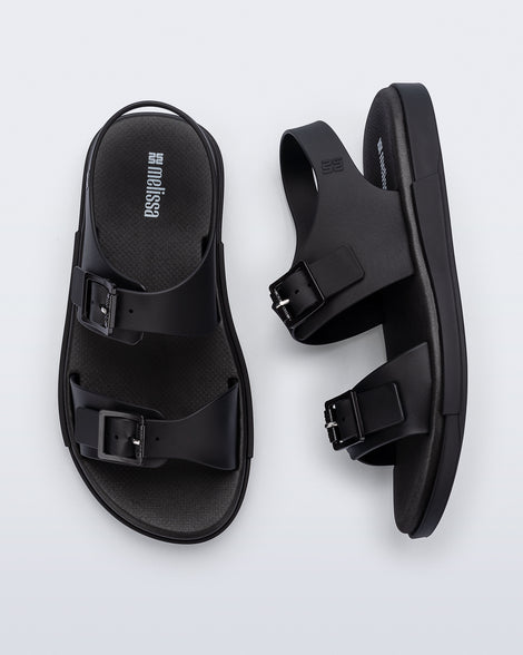 Side and top view of a pair of black Wave Sandals with two straps with buckles and a back strap