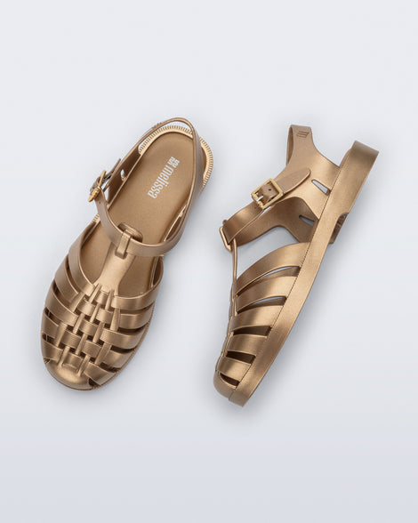 Top and side view of a pair of gold Possession fisherman sandals
