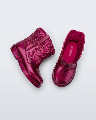 Top and side view of a pair of glitter pink Texas baby boots