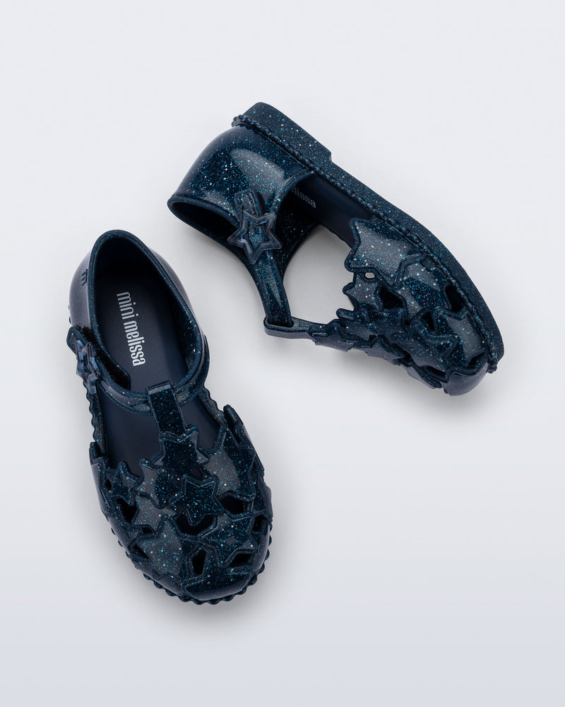 Side and top view of a pair of glitter blue Starry baby sandals