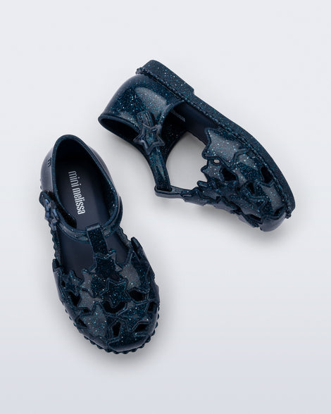 Side and top view of a pair of glitter blue Starry baby sandals