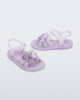 Side and angled view of a pair of pearly purple Hip Sky baby sandals with a glitter purple star on top