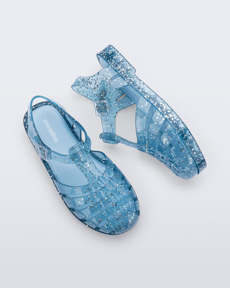 Side and top view of a pair of blue Possession kids sandals with heart glitter