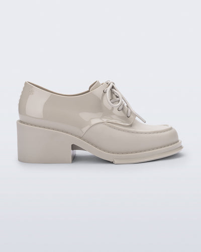 Side view of a beige Tailor loafer with laces