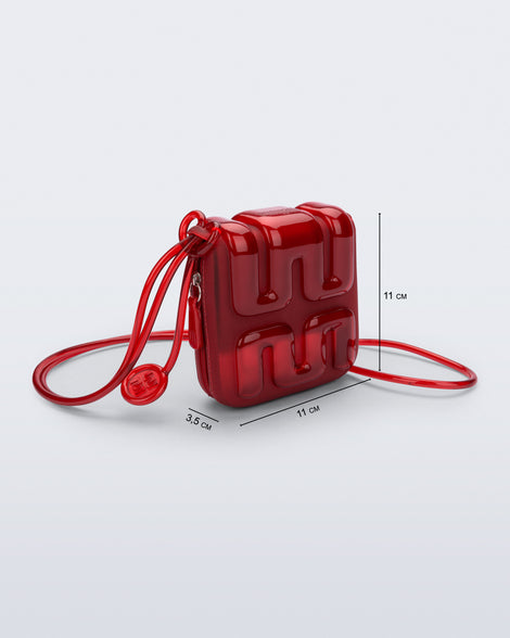 Front view of a red Jelly Wallet with inside pocket and zipper with bag dimensions: 11cm x 3.5cm x 11cm