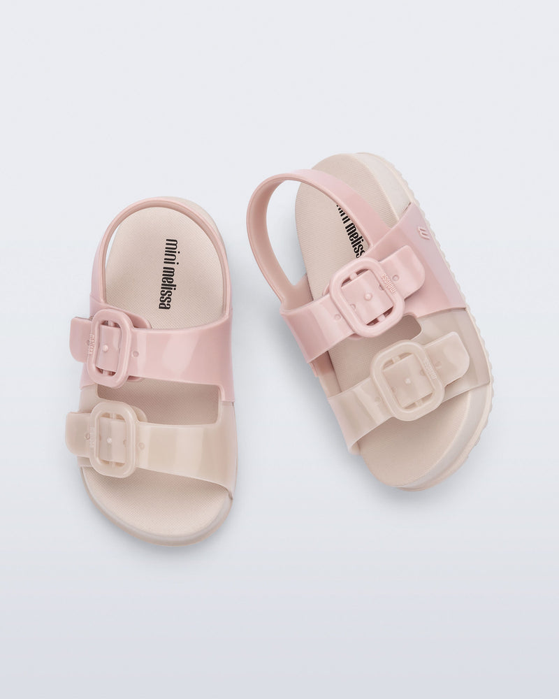 Top view of a pair of pink/beige Cozy baby slides