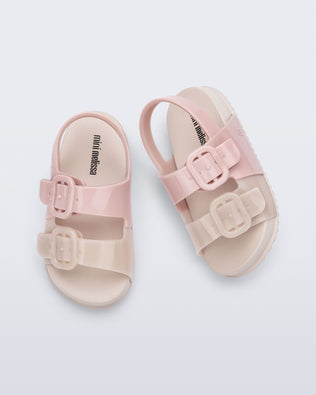 Top view of a pair of pink/beige Cozy baby slides
