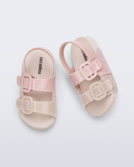 Top view of a pair of pink/beige Cozy baby slides
