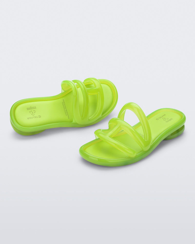 Angled view of a pair of green Jelly Slide x Telfar.