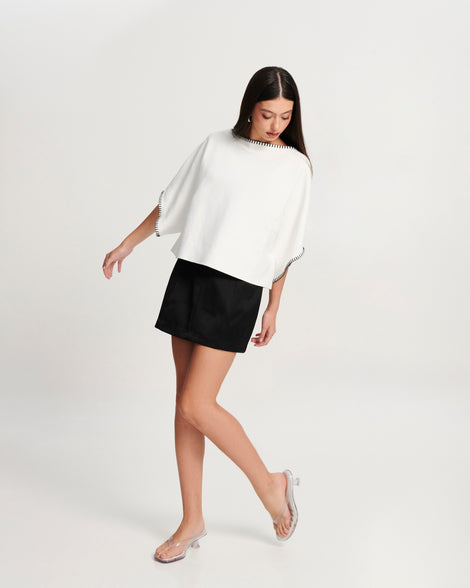 Model in a white shirt and black skirt wearing a pair of clear Flip Flop Kitten Heels with white insole