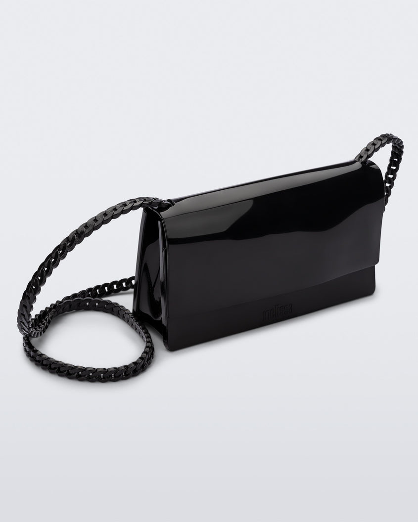 Angled view of the Melissa party handbag in black with braided strap.