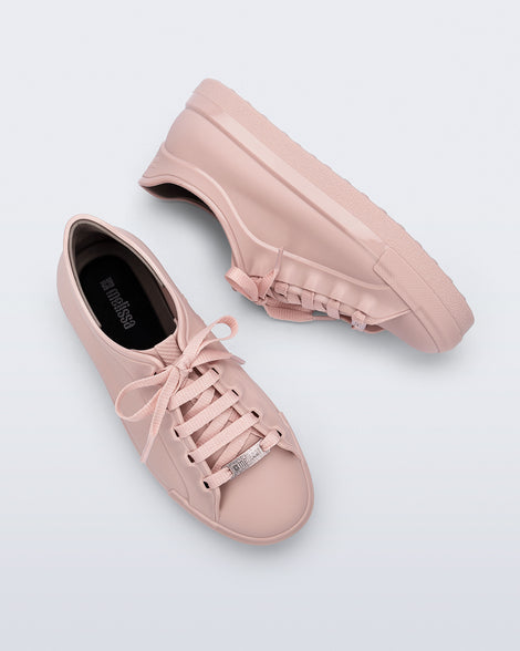 Top and side view of a pair of pink Wow Sneakers with pink laces