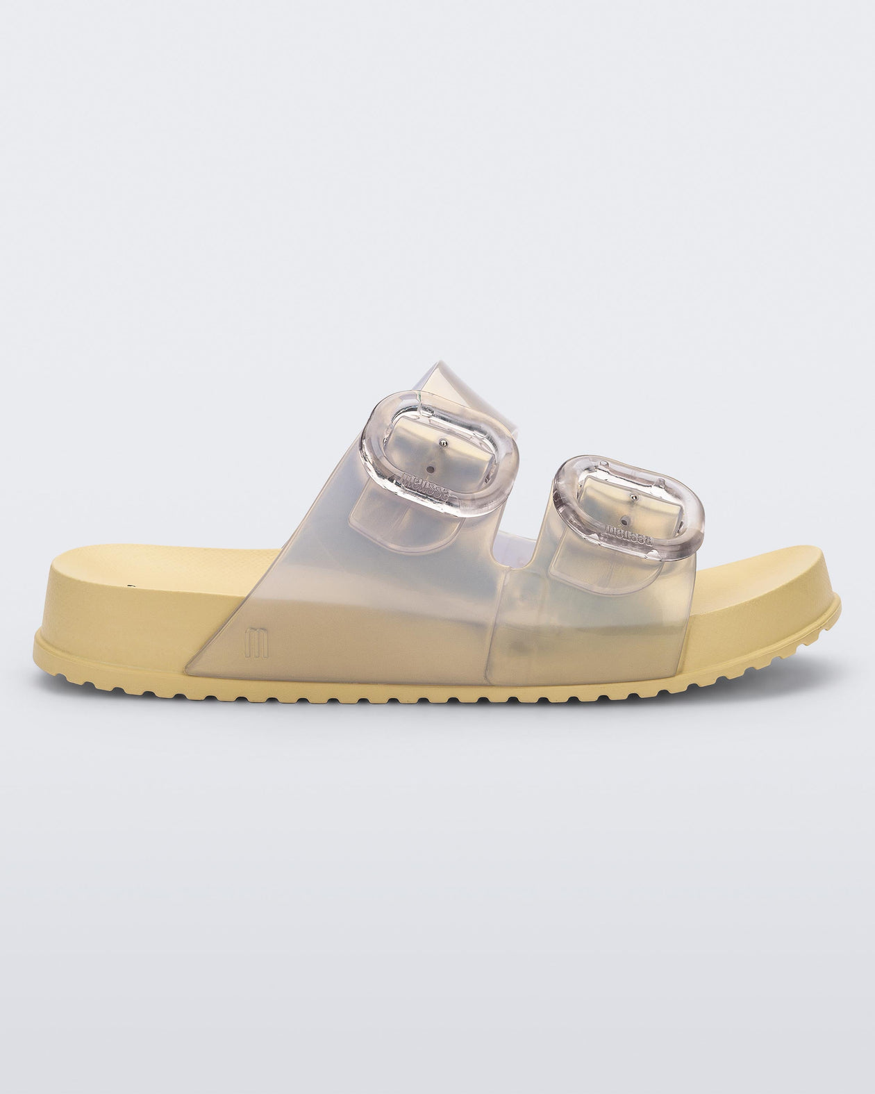 Side view of a pearly yellow Mini Melissa Cozy slide with two front straps with buckle details