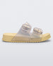 Side view of a pearly yellow Mini Melissa Cozy slide with two front straps with buckle details