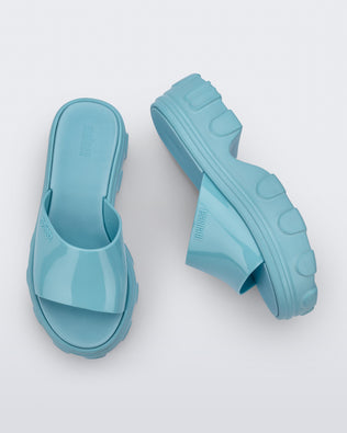 Side and top view of a pair of blue Ella slide platforms